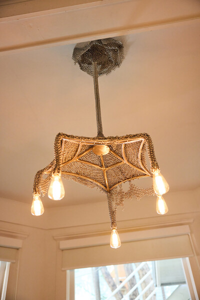 A chandelier by Panorammma (here, on display at Alcova Miami 2024) made using chain mail.