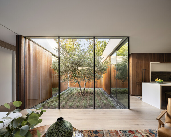 The couple spent $27, 250 on the interior windows, including the floor-to-ceiling glass panels that frame the courtyard.