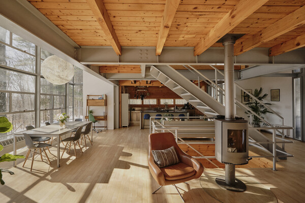 The living room has a wood-burning stove to help keep warm during the cold New York winters.