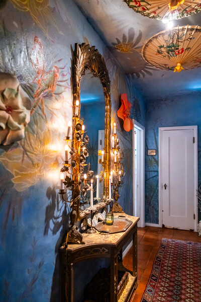 The vestibule is painted with underwater imagery and decorated with vintage furnishings.