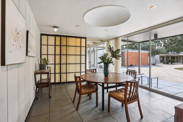 A sliding rice paper screen separates the living and dining rooms.