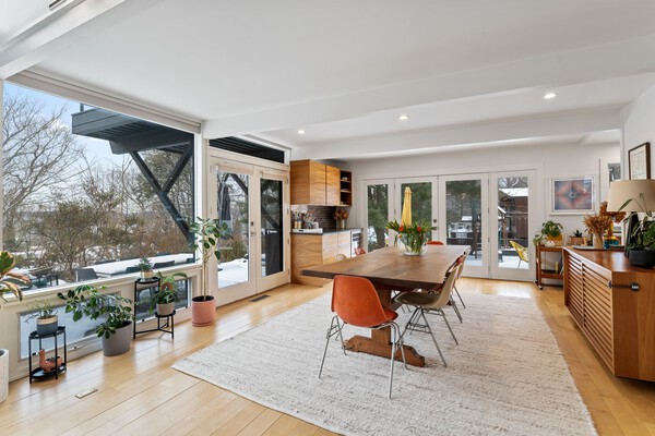 The dining room, equipped with a built-in bar and wine refrigerator, opens to the wrap-around patio.